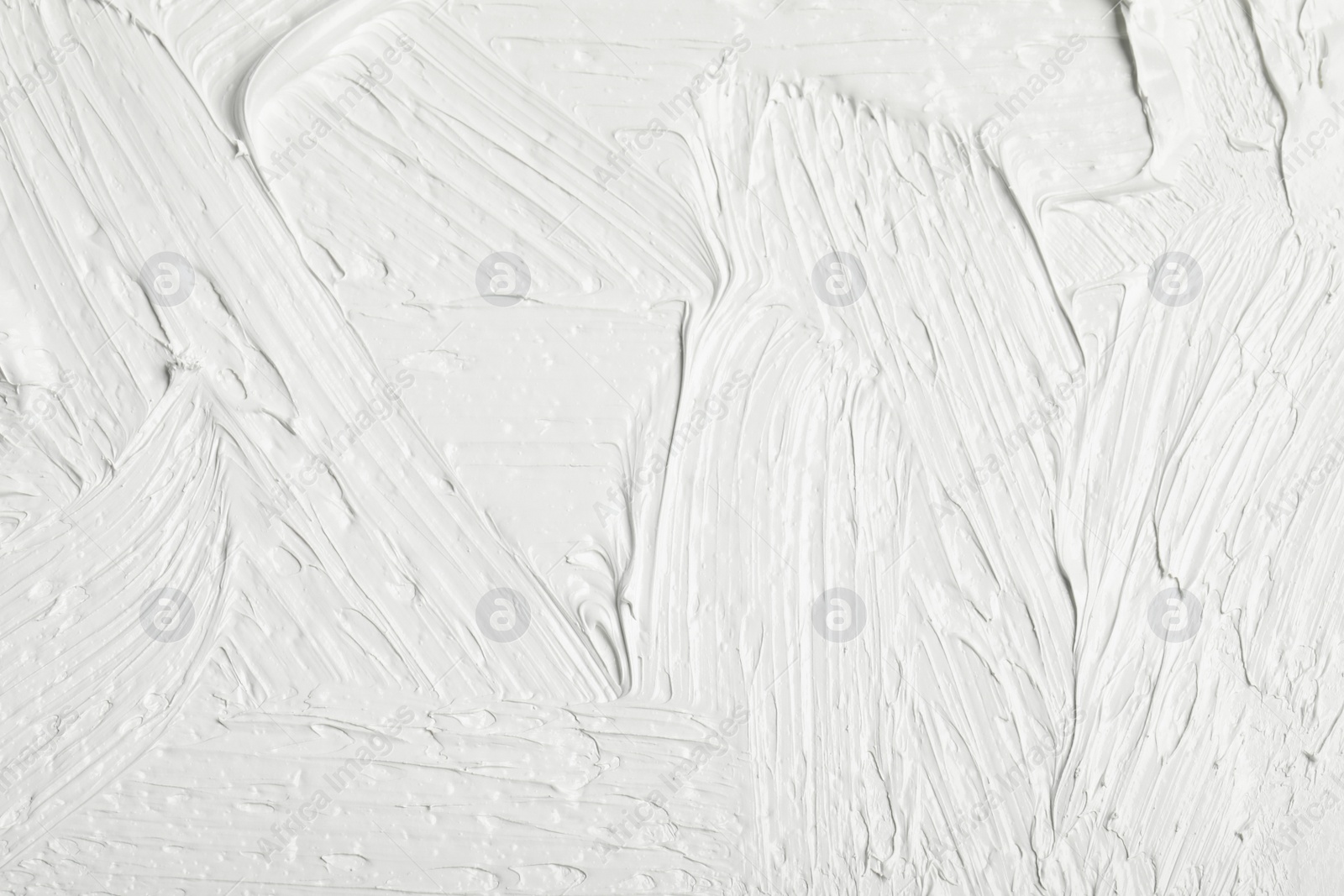 Photo of Texture of white oil paint as background, closeup