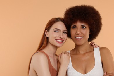 Portrait of beautiful young women on beige background
