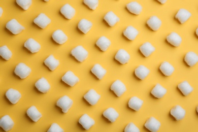 Photo of Many fluffy cotton balls on color background, flat lay