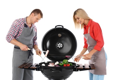 Happy couple cooking on barbecue grill, white background