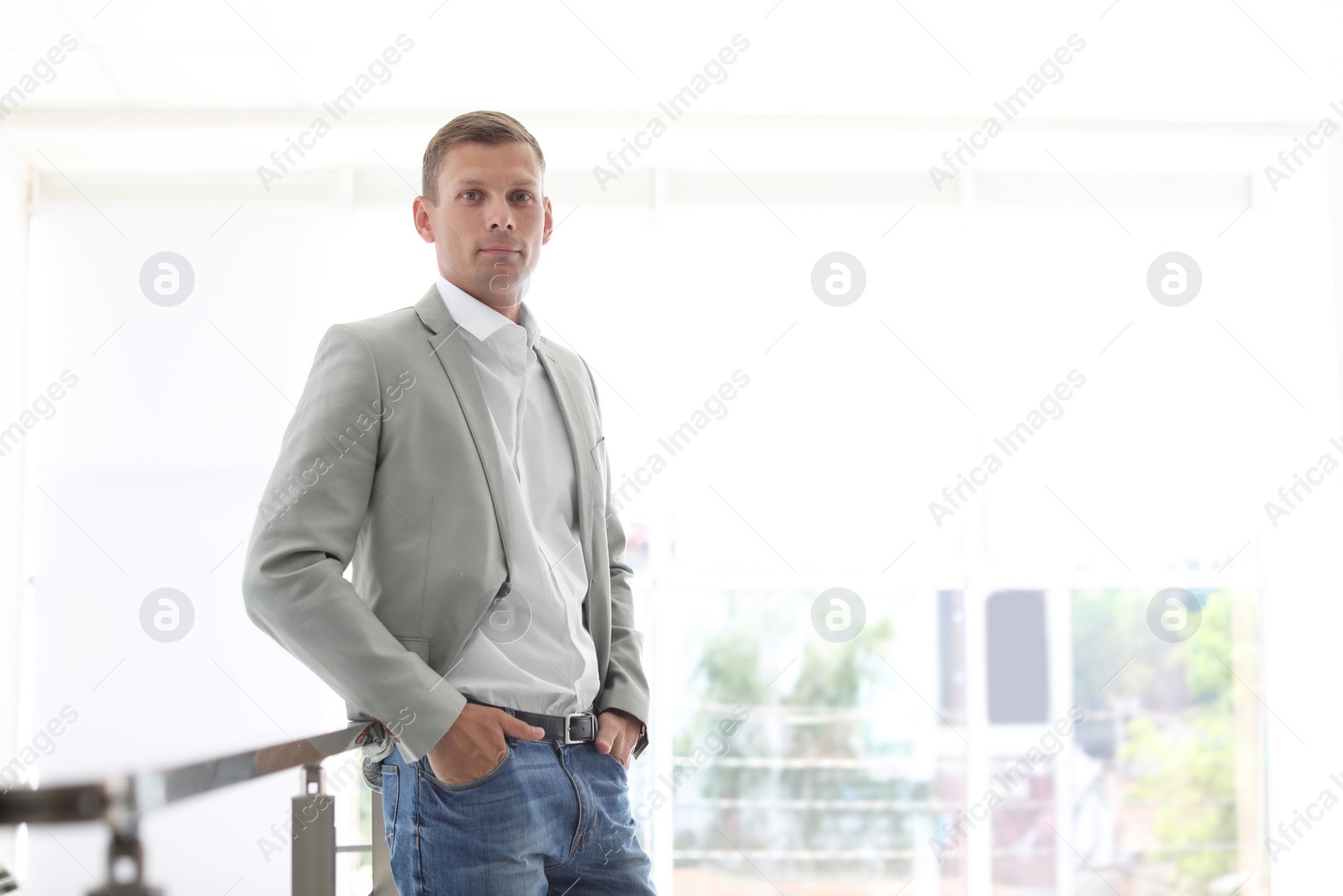 Photo of Young man standing in office room. Time to work