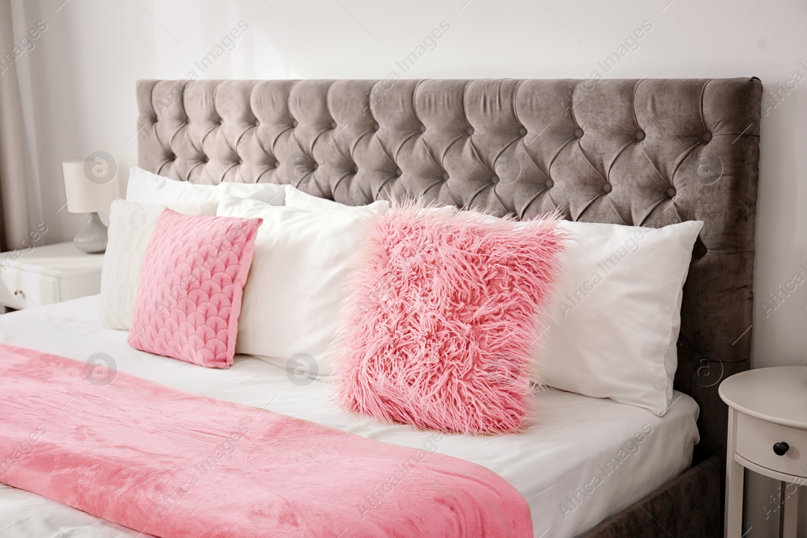 Photo of Fluffy pillows on bed in hotel room