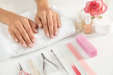 Woman waiting for manicure and tools on table, closeup. Spa treatment