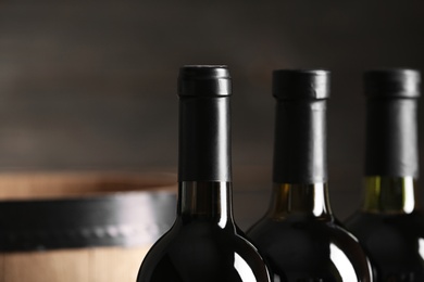 Bottles of tasty wine on dark background, closeup