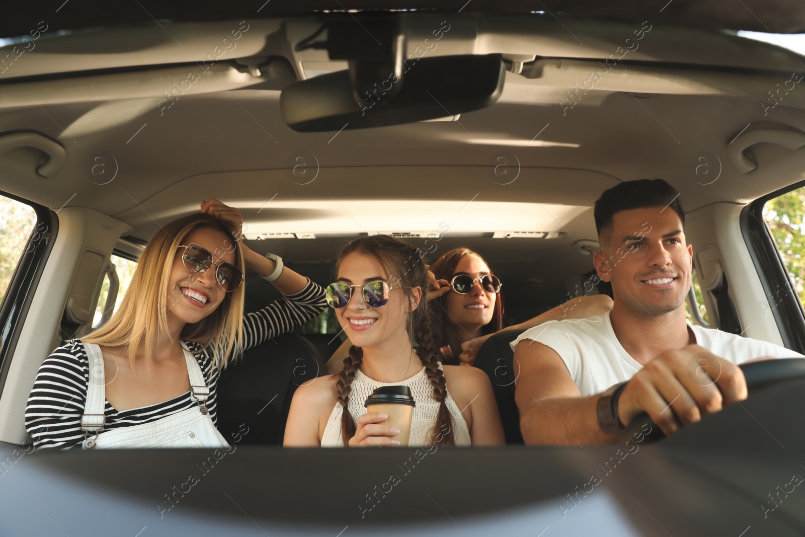 Photo of Happy friends together in car on road trip