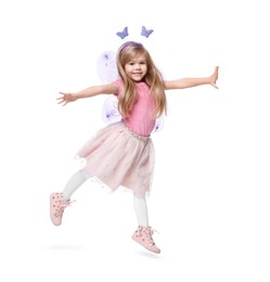 Photo of Cute little girl in fairy costume with violet wings jumping on white background