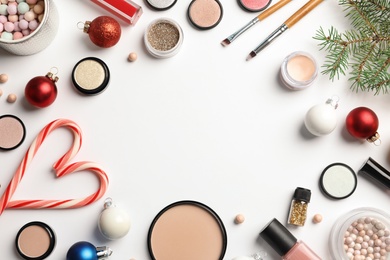 Photo of Flat lay composition with makeup products and Christmas decor on white background. Space for text