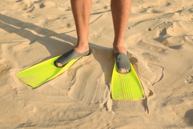 Photo of Man in flippers on sand, closeup view