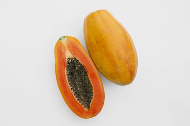 Fresh ripe papaya fruits on white background, flat lay