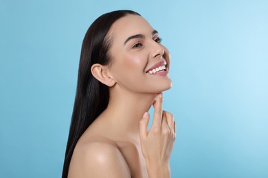 Photo of Portrait of attractive young woman on light blue background. Spa treatment