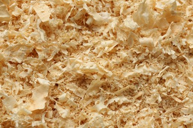 Photo of Dry natural sawdust as background, top view