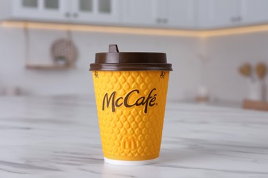 MYKOLAIV, UKRAINE - AUGUST 12, 2021: Hot McDonald's drink on marble table in kitchen