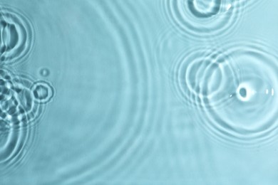 Photo of Closeup view of water with circles on turquoise background