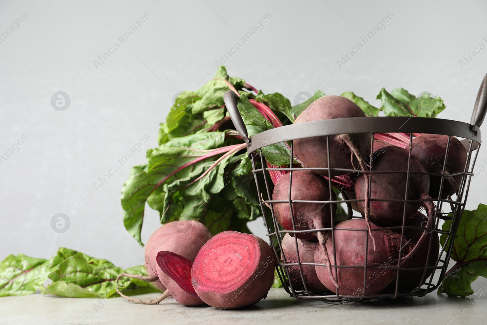 Photo of Fresh ripe beets on light grey table