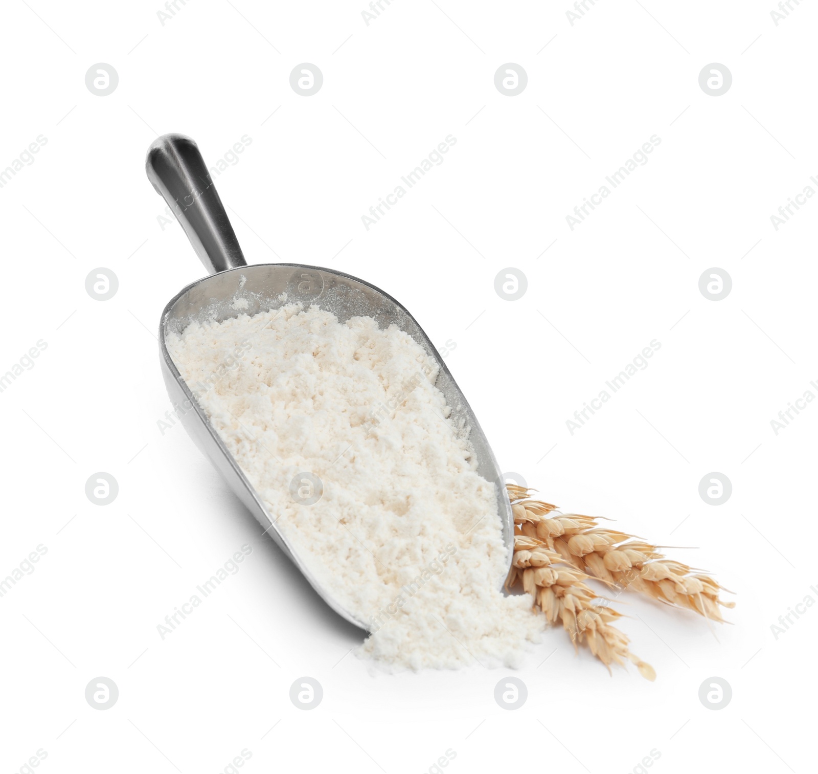 Photo of Organic flour, metal scoop and spikelets isolated on white