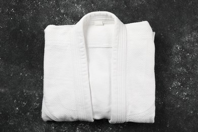 Photo of White kimono on gray textured background, top view