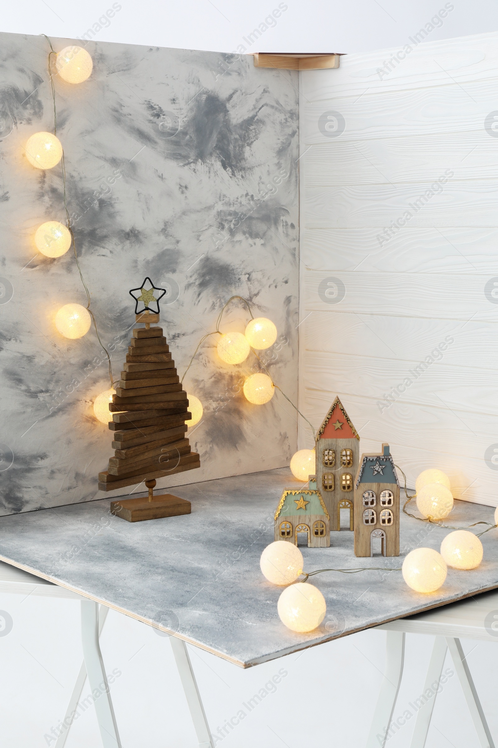 Photo of Christmas decor and double-sided backdrops on table in photo studio