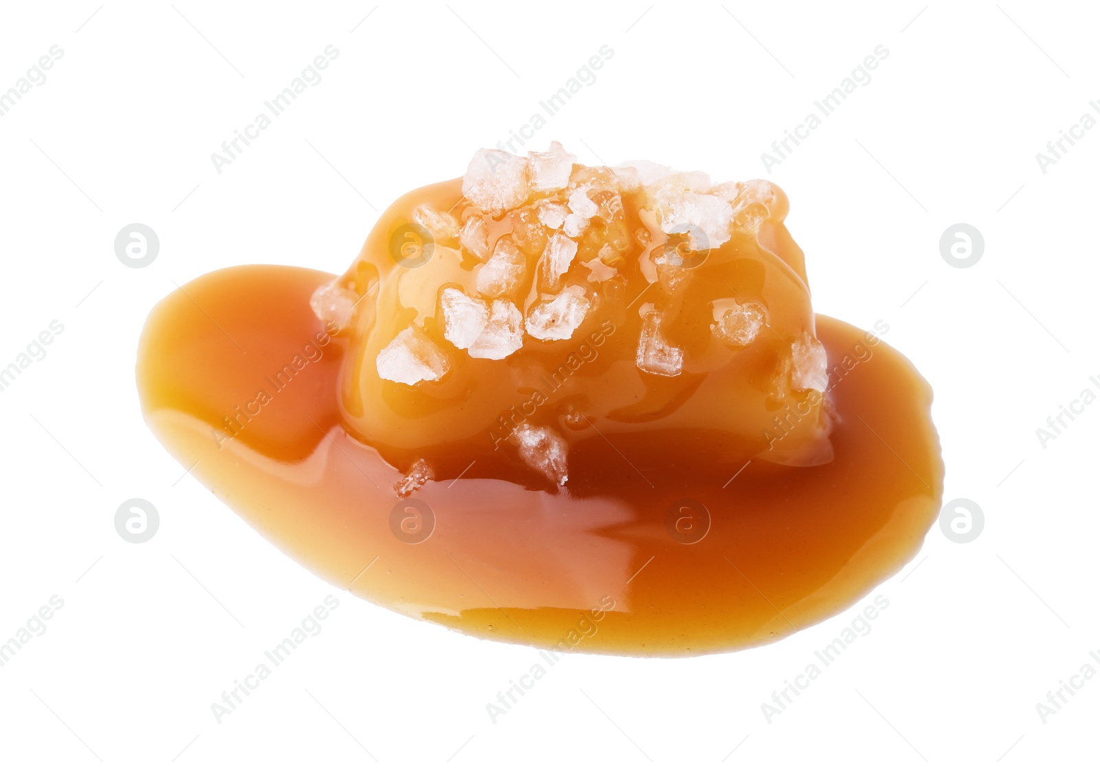 Photo of Yummy caramel candy and sea salt isolated on white