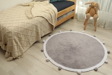 Stylish soft rug on floor in children's room