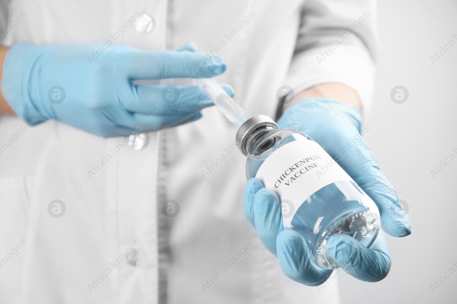 Photo of Doctor filling syringe with chickenpox vaccine, closeup. Varicella virus prevention