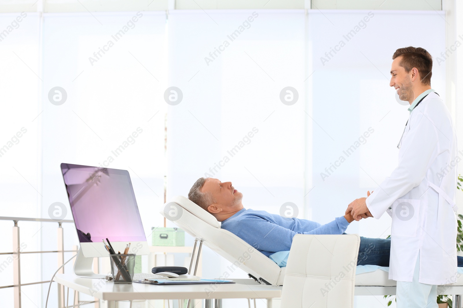 Photo of Doctor checking mature patient pulse in hospital