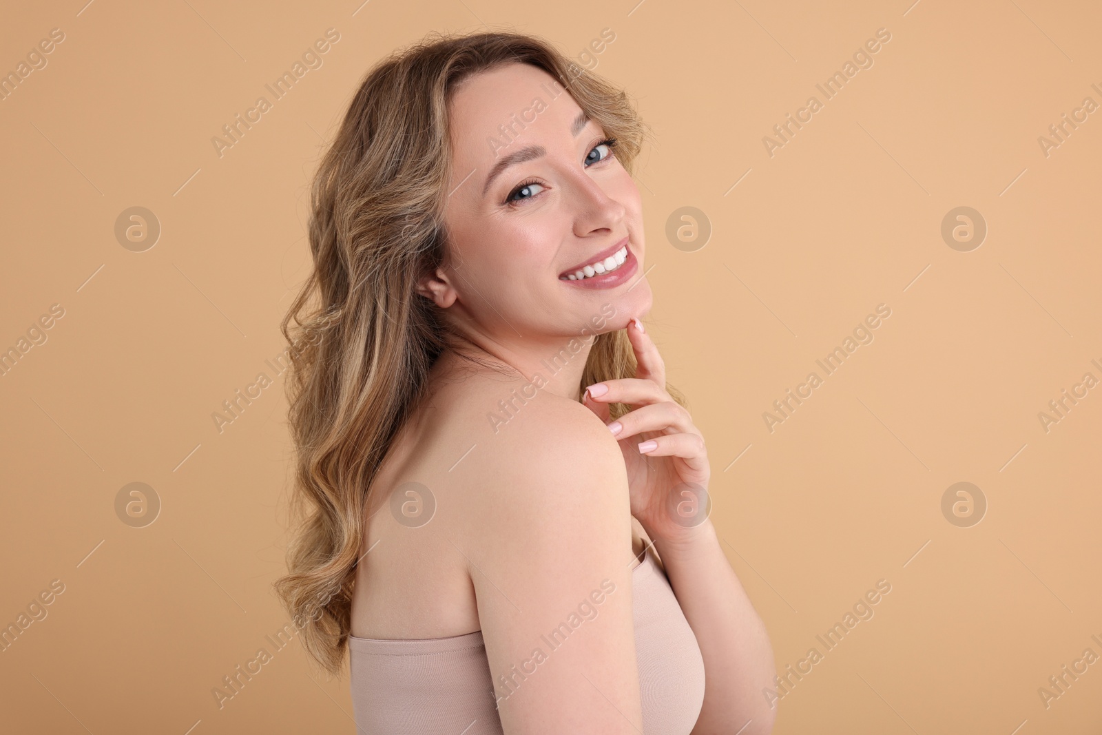 Photo of Portrait of smiling woman on beige background