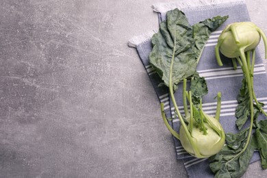 Photo of Whole ripe kohlrabi plants on grey table, flat lay. Space for text