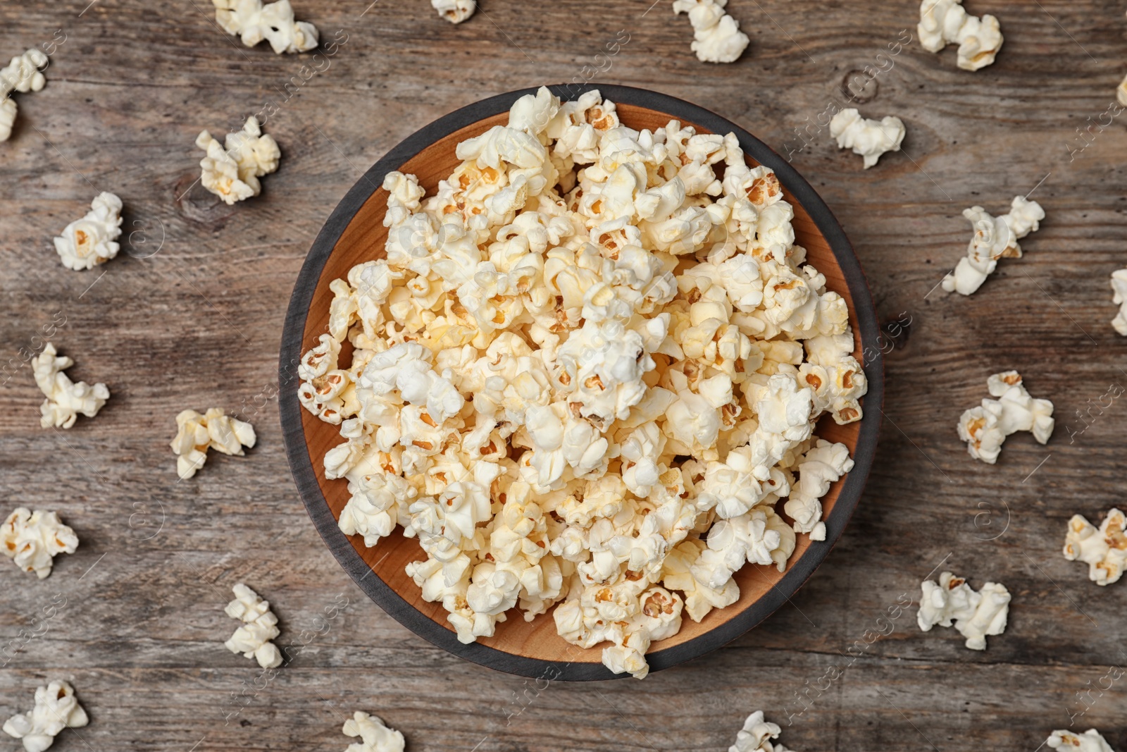 Photo of Flat lay composition with popcorn on wooden background