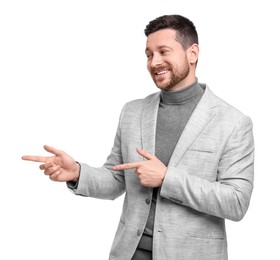 Handsome bearded businessman in suit pointing at something on white background