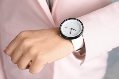 Businesswoman with stylish wrist watch, closeup. Time management