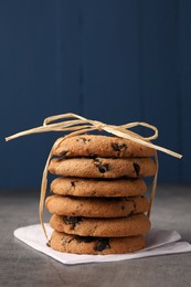 Photo of Stack of delicious chocolate chip cookies on grey table