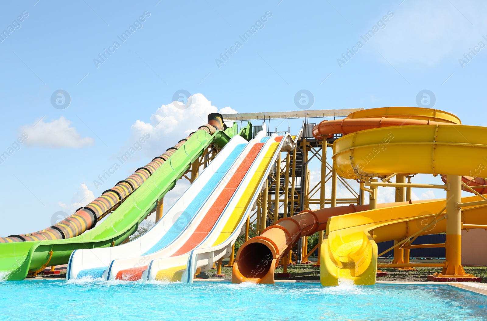 Photo of Different colorful slides in water park on sunny day