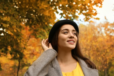 Photo of Young beautiful woman with hat in park. Autumn walk