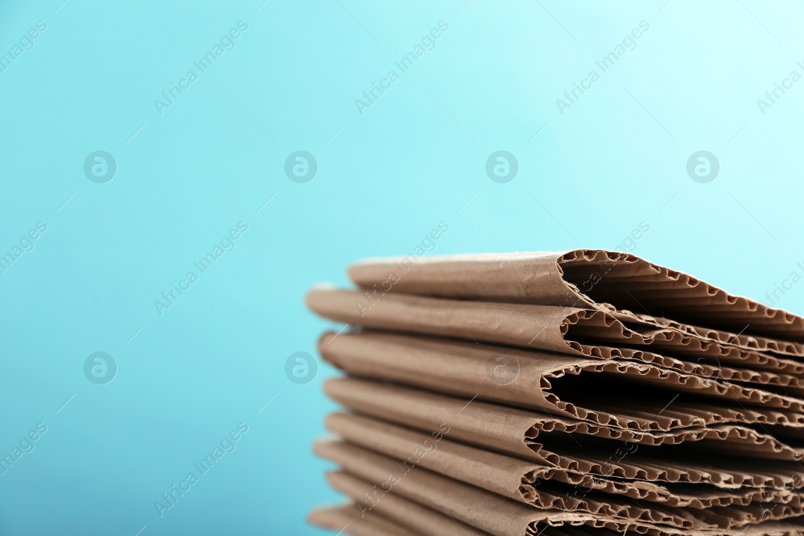 Photo of Stack of cardboard for recycling on color background. Space for text