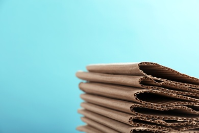 Photo of Stack of cardboard for recycling on color background. Space for text
