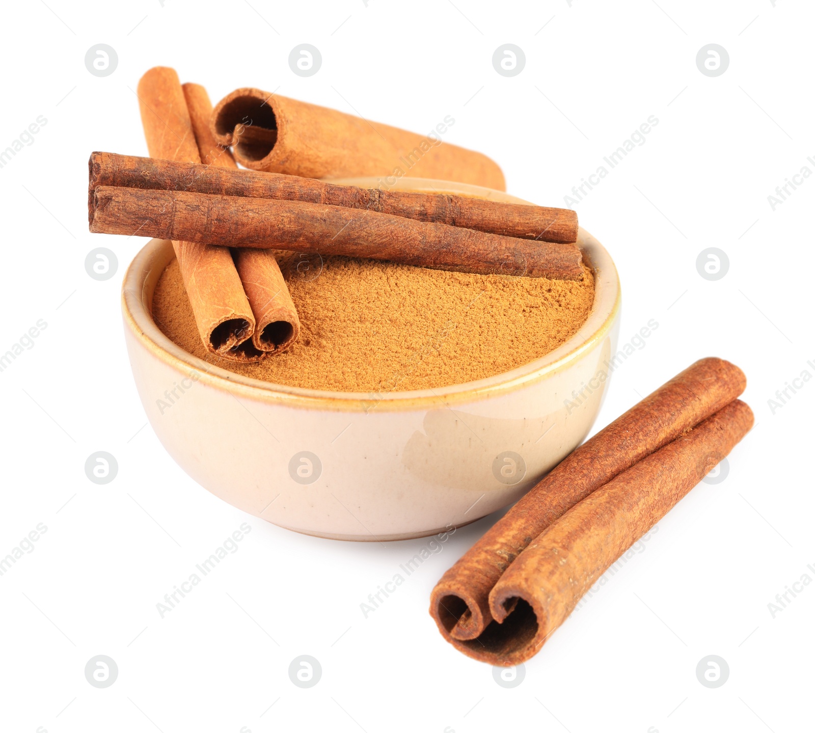 Photo of Dry aromatic cinnamon sticks and powder isolated on white