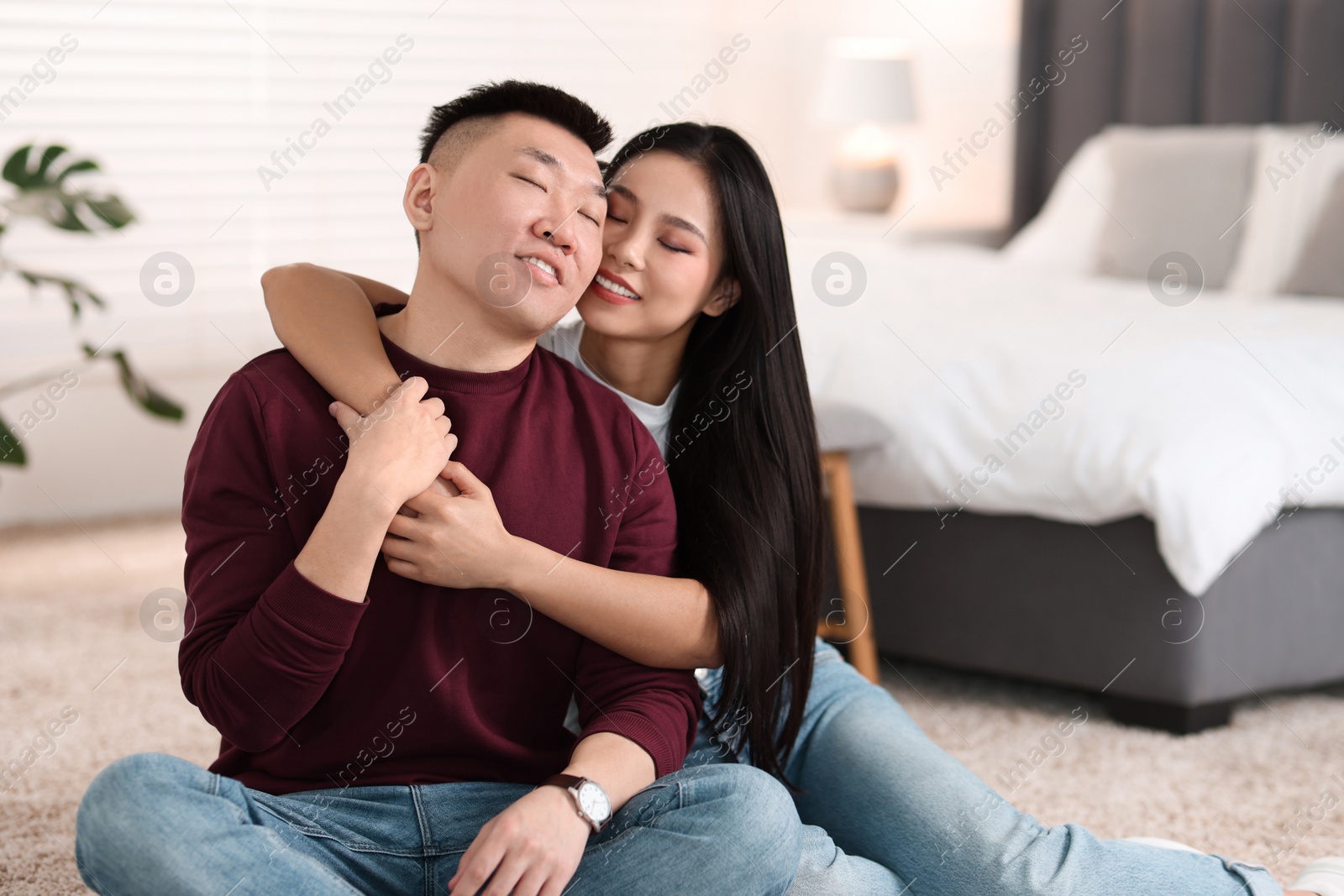 Photo of Lovely young couple on floor at home