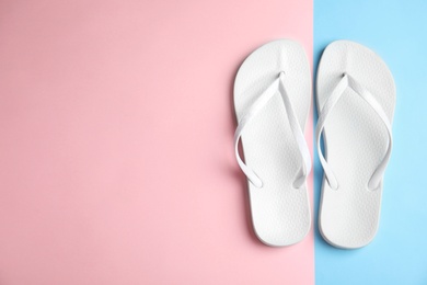 Flat lay composition with flip flops on color background, space for text. Beach objects