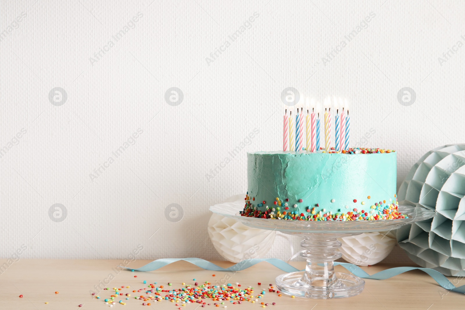 Photo of Stand with fresh delicious cake and birthday decorations on table. Space for text