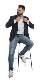 Photo of Handsome young man sitting on stool against white background