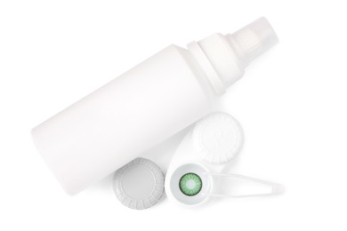 Case with color contact lenses, bottle of cosmetic product and tweezers isolated on white, top view