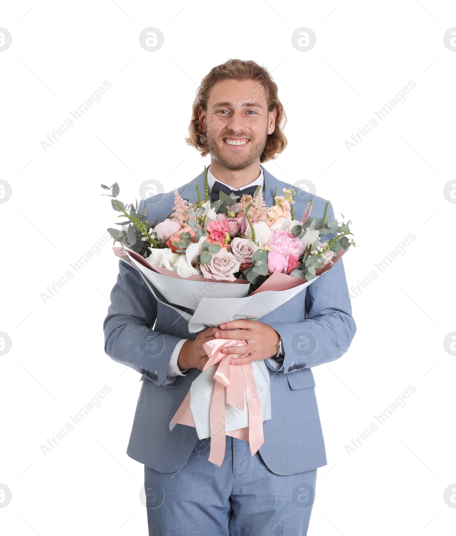 Photo of Young handsome man in stylish suit with beautiful flower bouquet on white background