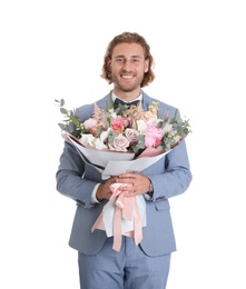 Young handsome man in stylish suit with beautiful flower bouquet on white background