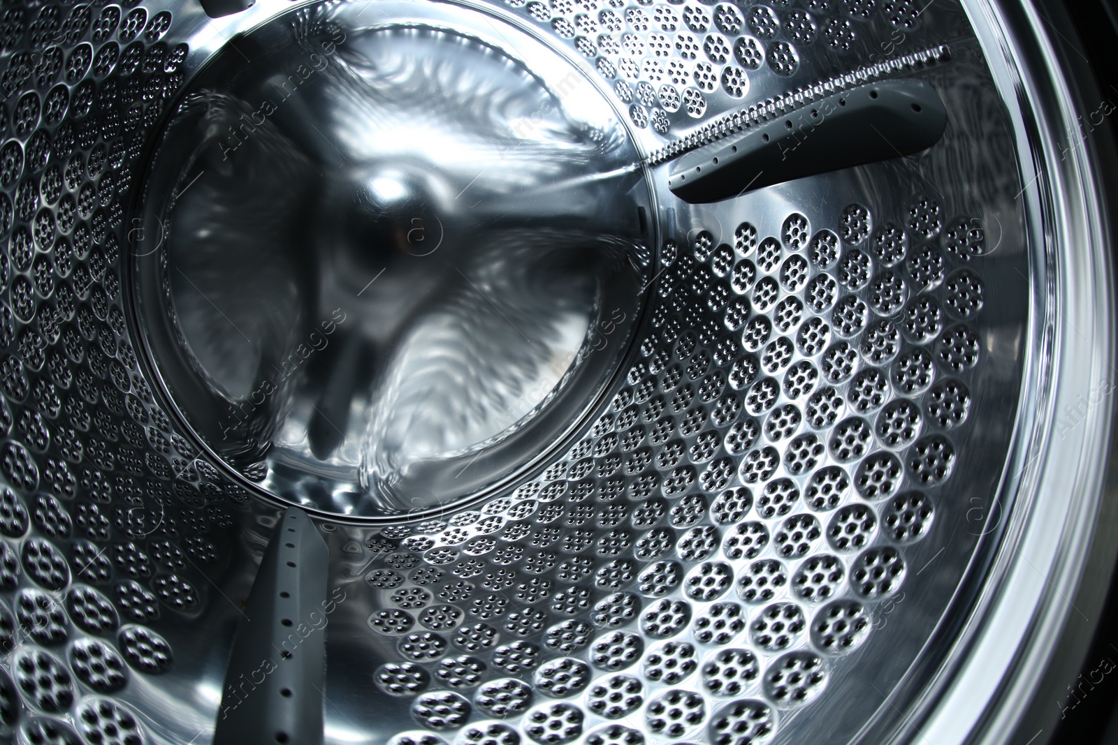 Photo of Empty washing machine drum, closeup view. Laundry day