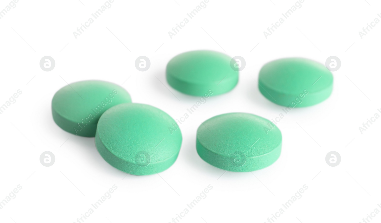 Photo of Many light green pills isolated on white