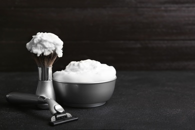 Photo of Shaving accessories on table against dark background with space for text