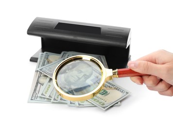 Photo of Woman checking dollar banknotes with currency detector and magnifying glass on white background, closeup. Money examination device