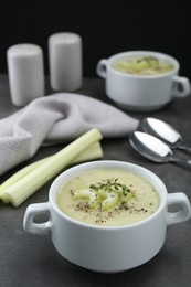 Bowl of delicious celery soup on gray table