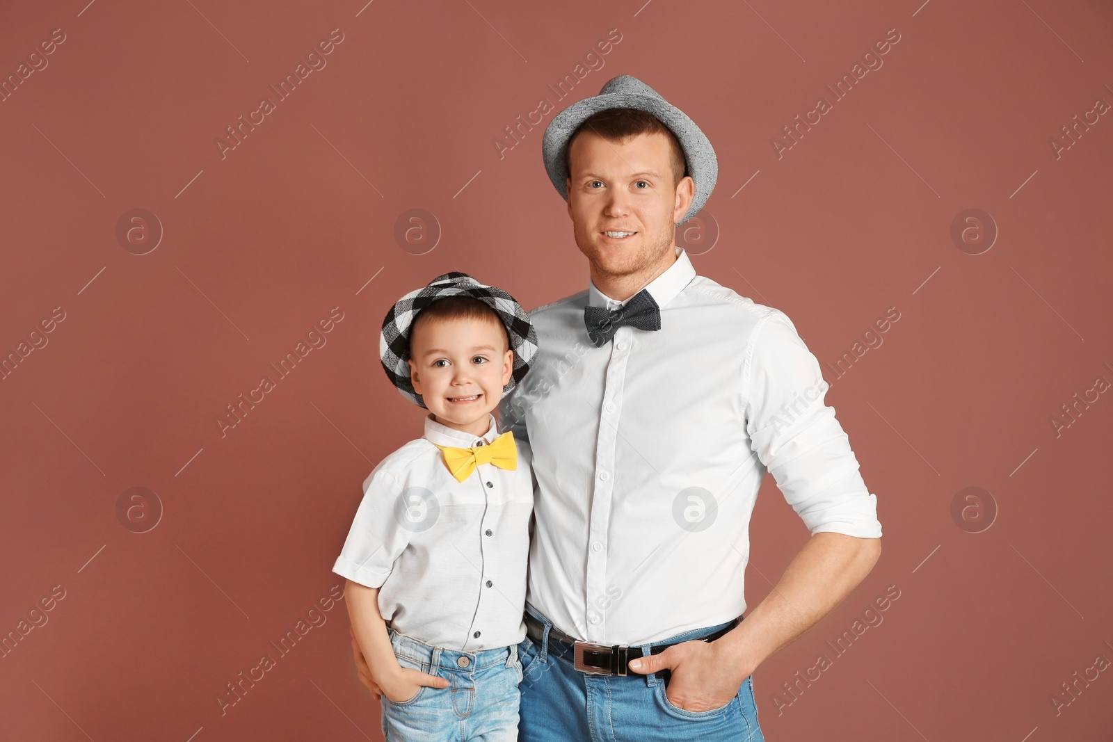 Photo of Dad and his son on color background. Father's day celebration