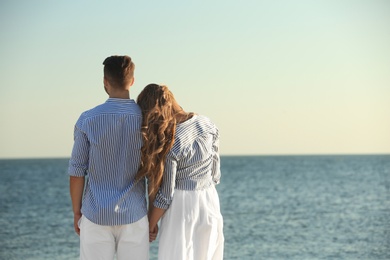 Happy young couple resting together on beach